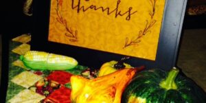Thanksgiving display with pumpkins and corn.