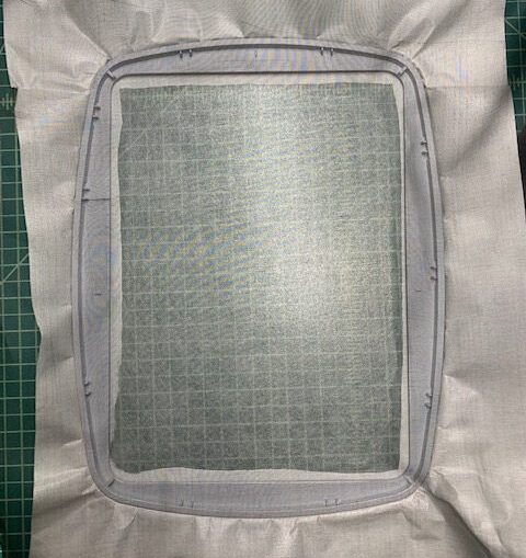 Smiling woman with short brown hair wearing a black top and pearl necklace.