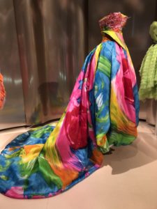 Colorful, flowing fabric draped elegantly on a mannequin.