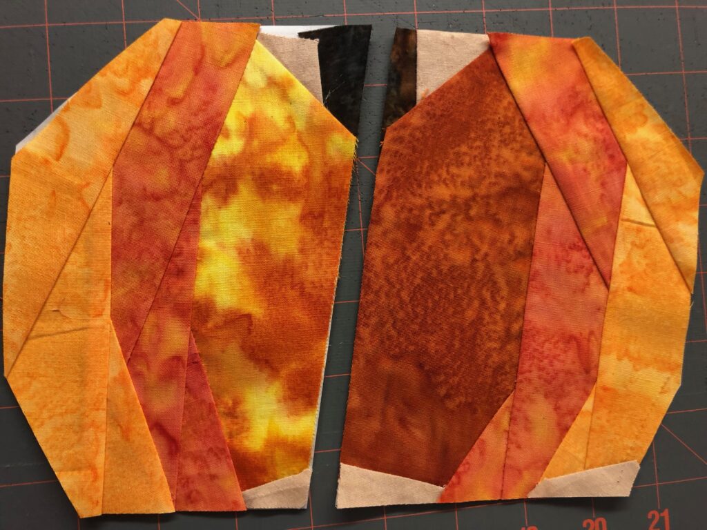 two halves of paper pieced pumpkin