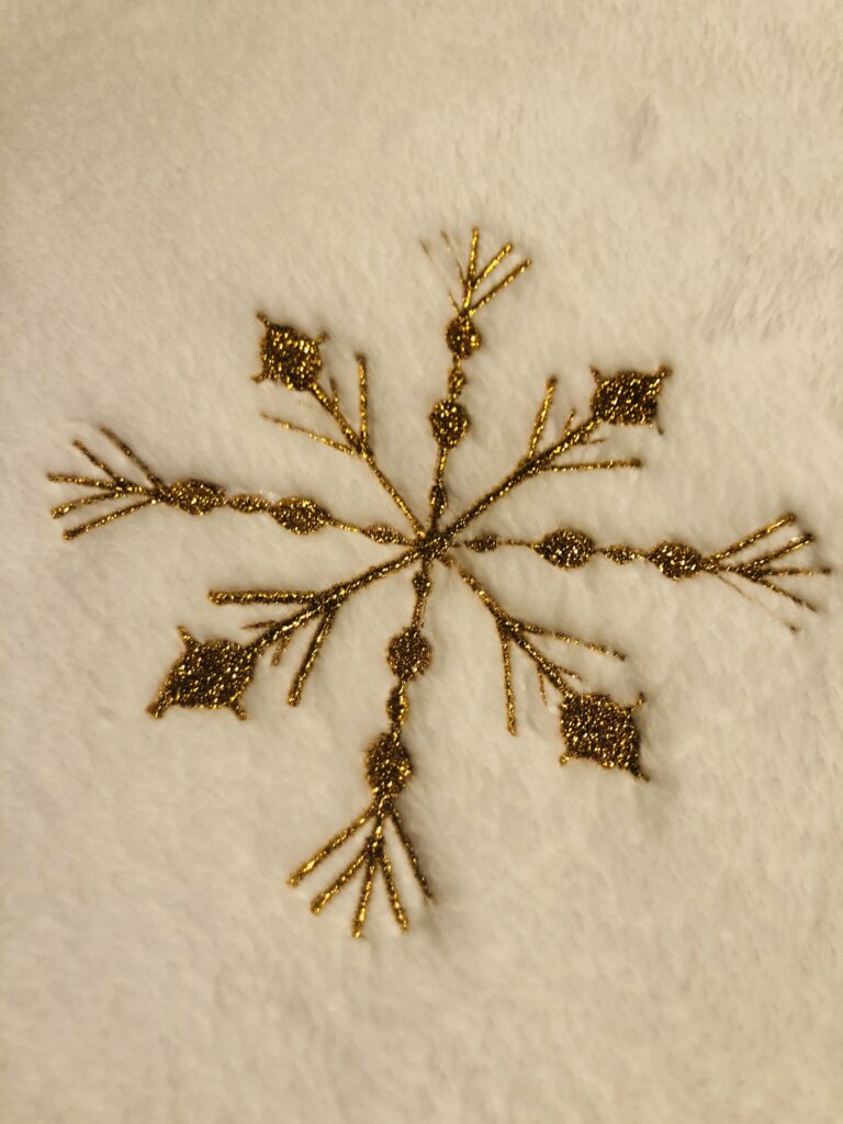 metallic snowflake on throw right side