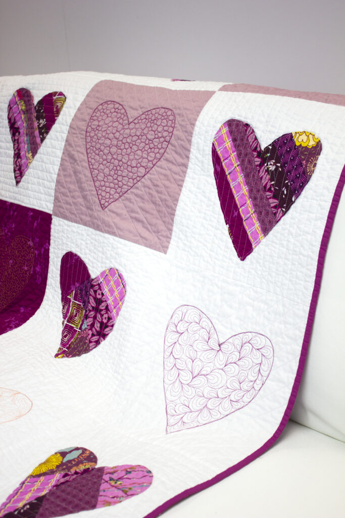 paper pieced heart quilt on couch