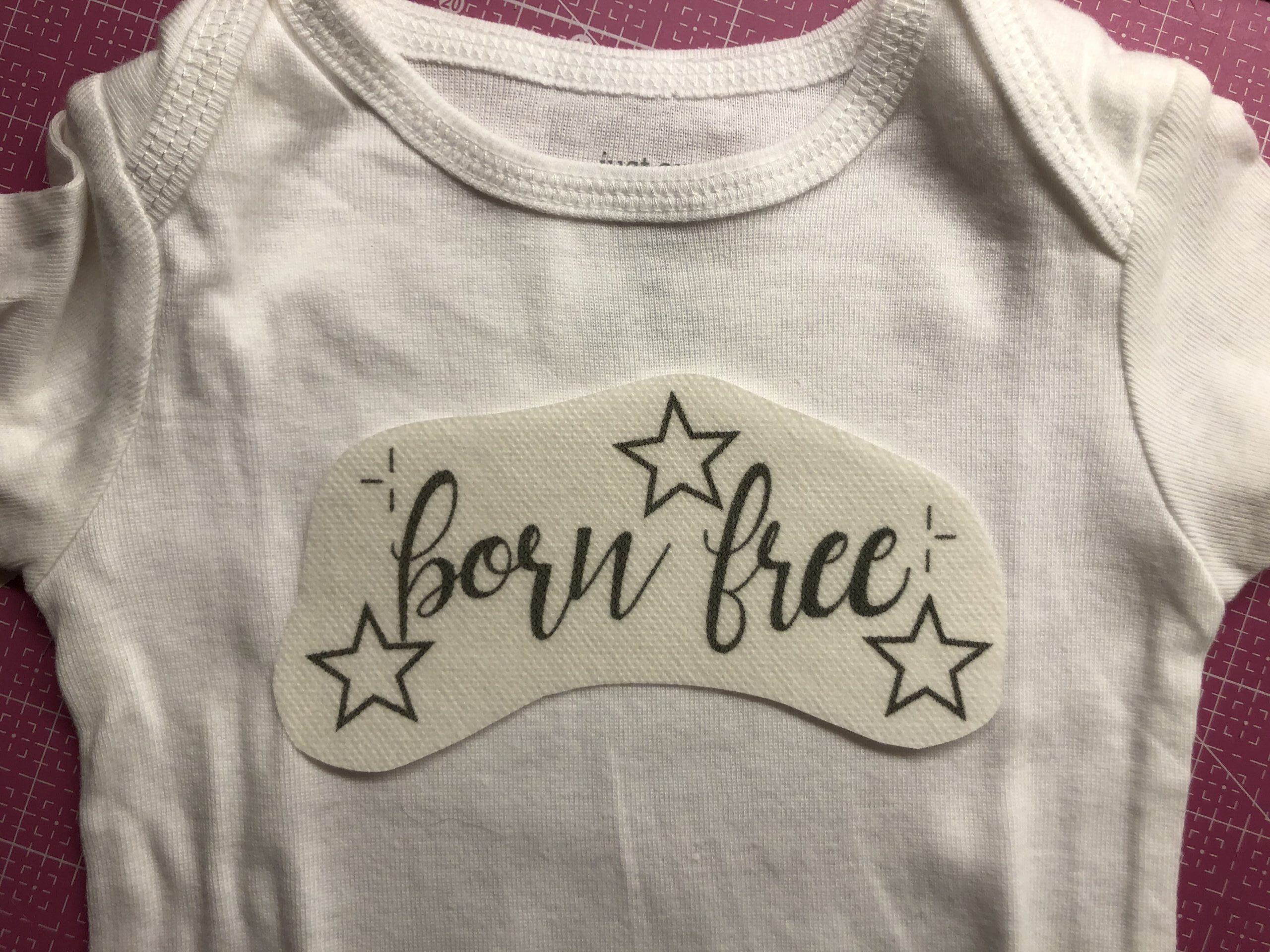 embroidered onesie with stabilizer positioned on front