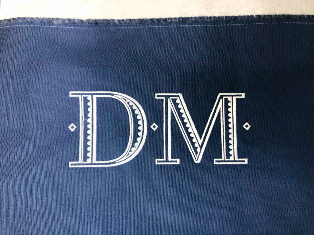 three total diamonds embroidered on bag
