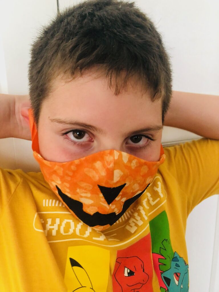 kid wearing costume face mask