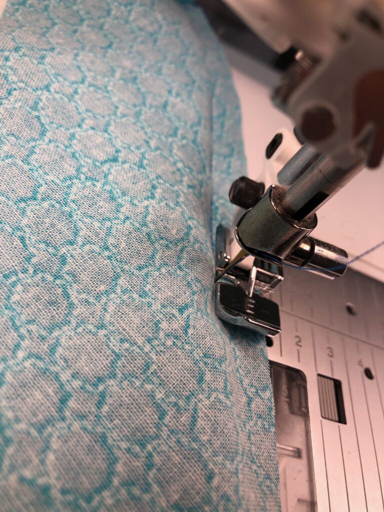 stitching fabric trim to tea towel
