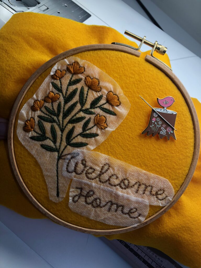 finished Welcome Home Embroidery with stabilizer intact