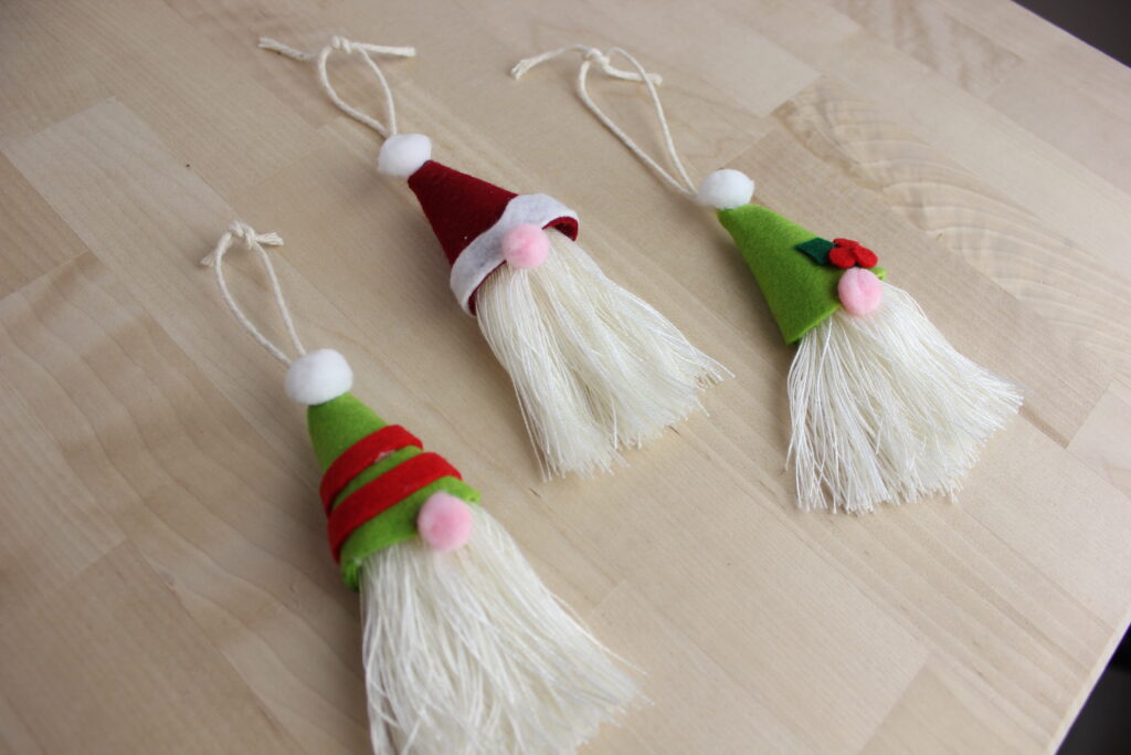santa and elves ornaments on wooden surface
