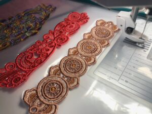 Intricately designed red and beige embroidered lace trims.