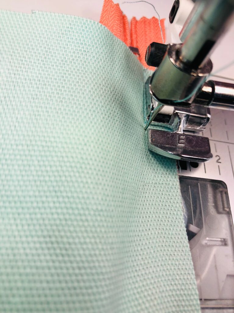 stitch opposite zipper tape edge