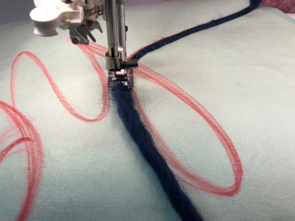 continuing to couch yarn onto fabric