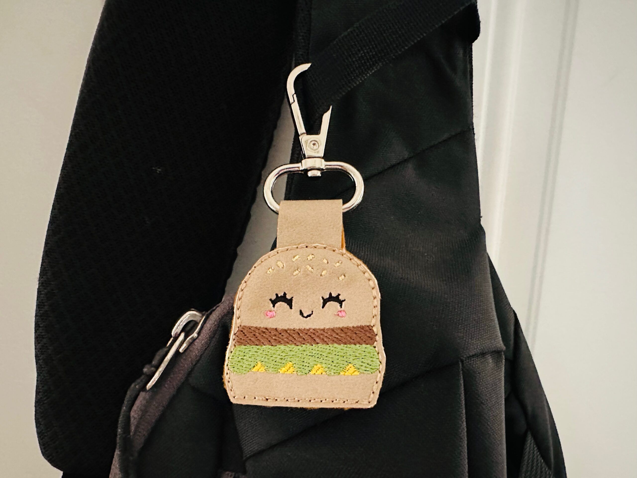 cheeseburger charm hanging on backpack