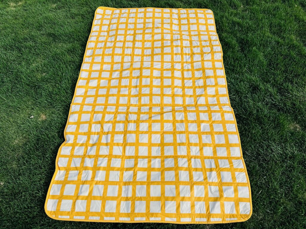 picnic blanket on grass ready for folding