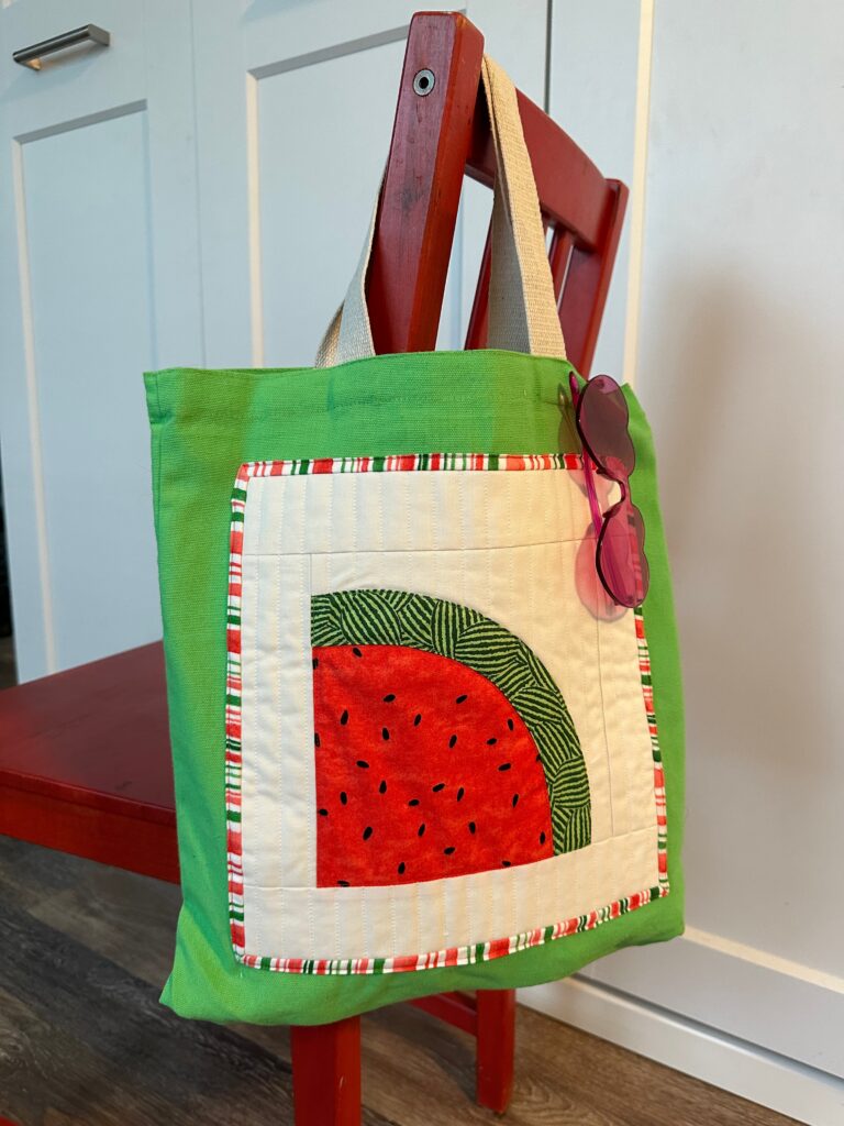 finished watermelon tote on red chair