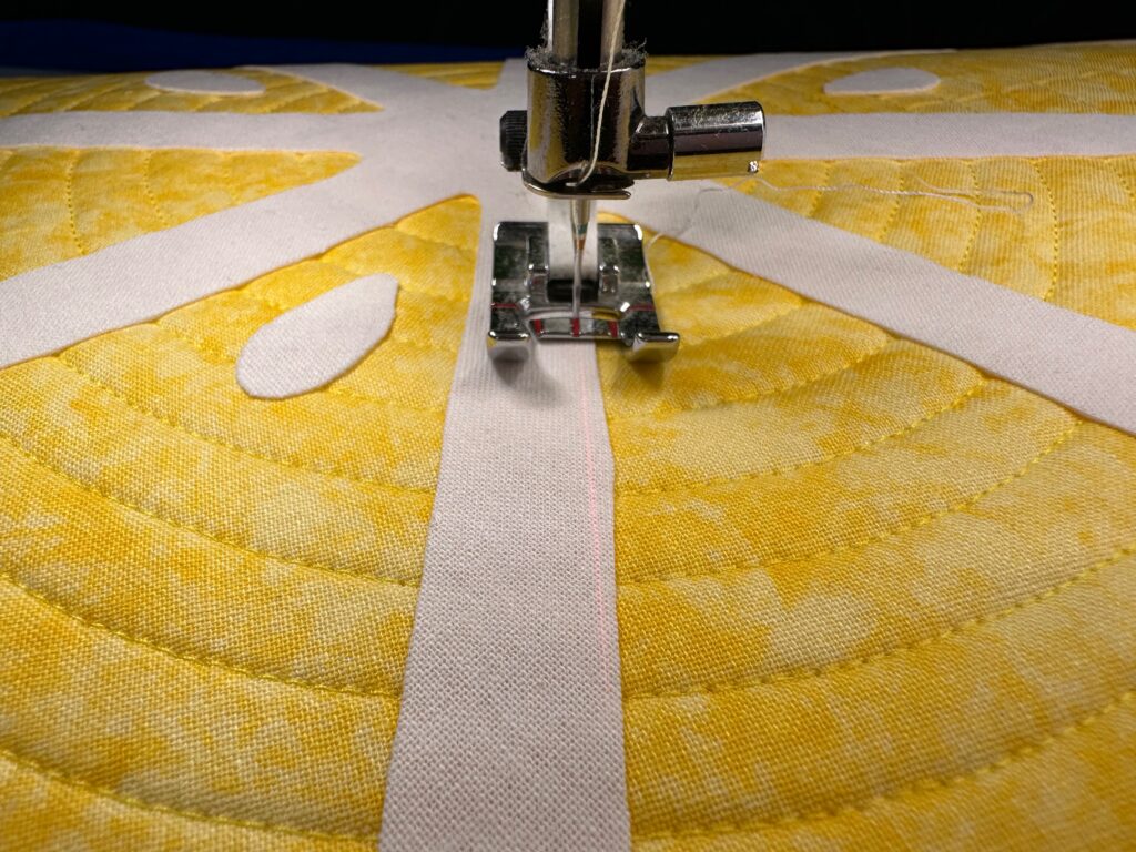 stitching the appliques for citrus slice placemats