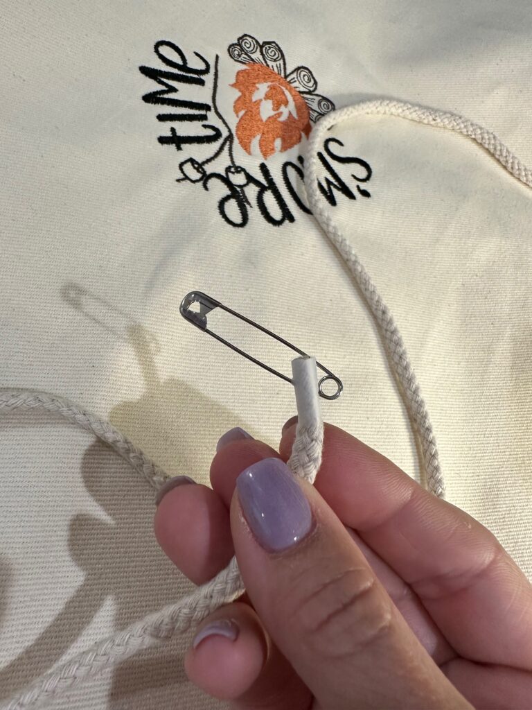 insert safety pin through cording end