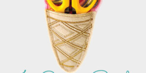 Ice cream-shaped pouch holding yellow scissors.