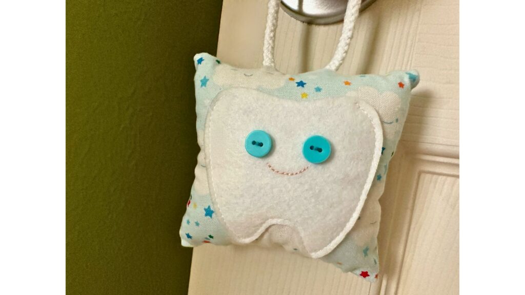 finished tooth fairy pillow hanging on doorknob