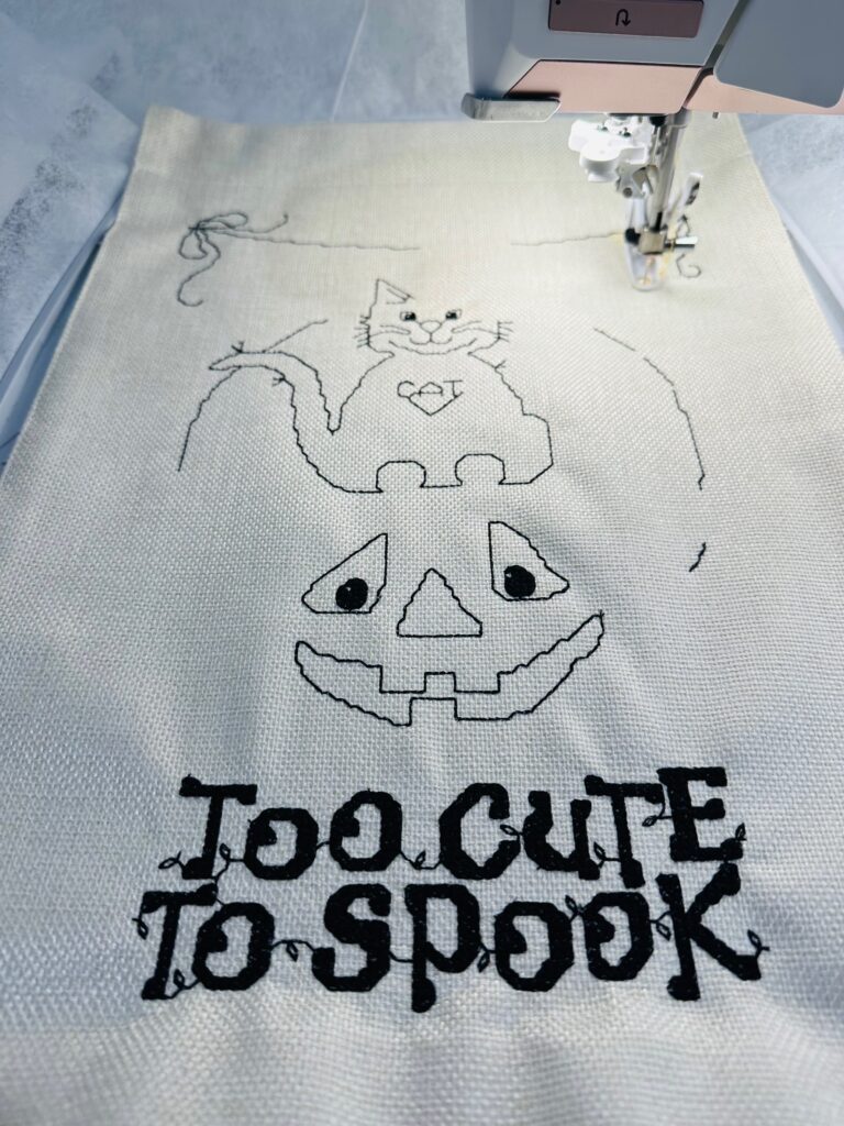 Halloween cross stitch in progress at sewing machine