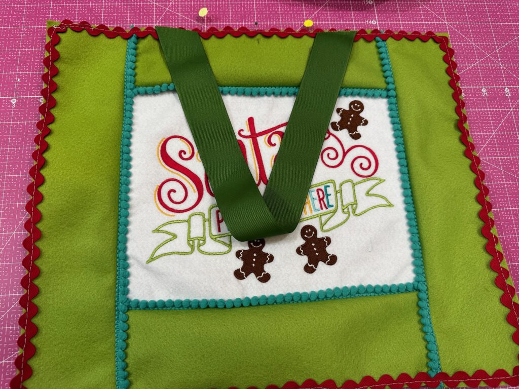 ends of ribbon pinned on Santa sign