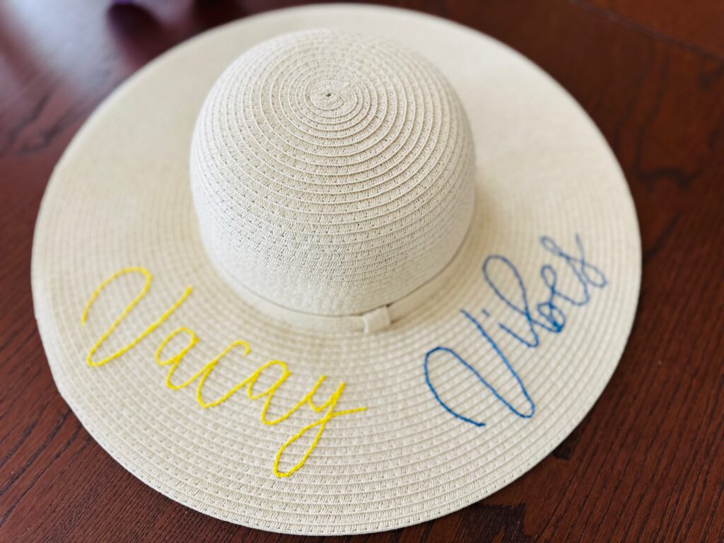 finished embroidered sunhat on dark table