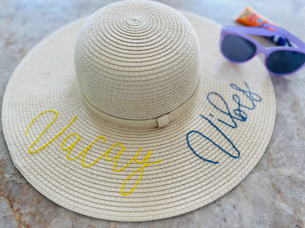 Embroidered Sunhat with sunglasses on table