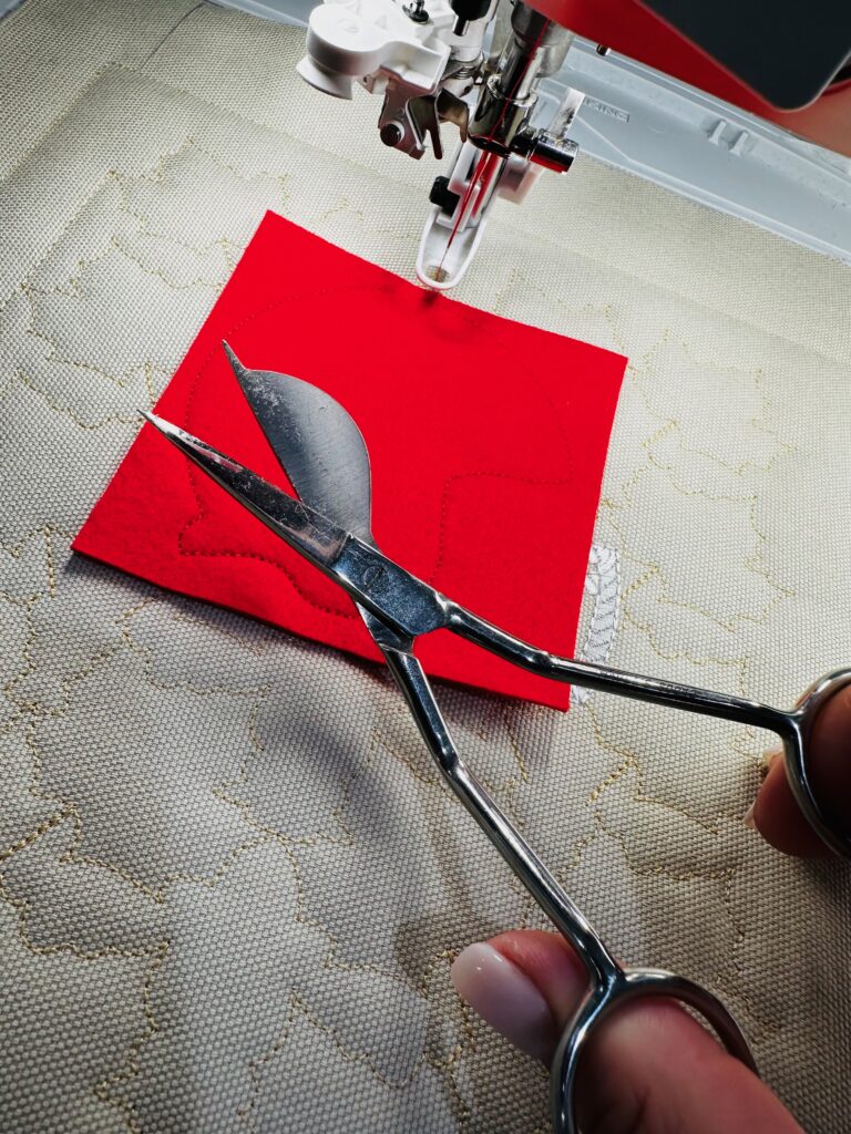 using applique scissors to trim football helmet fabric