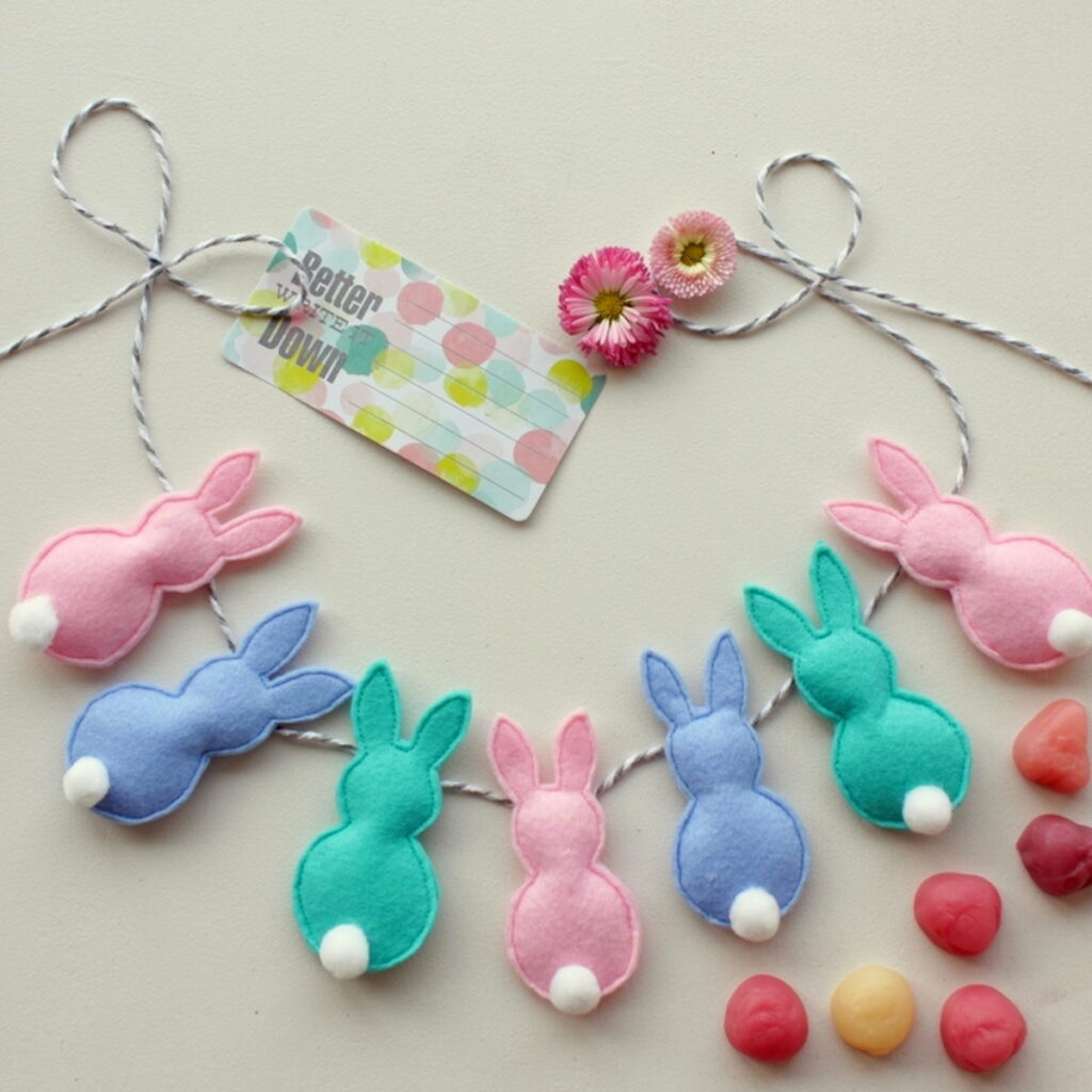 felty bunny garland on table with props