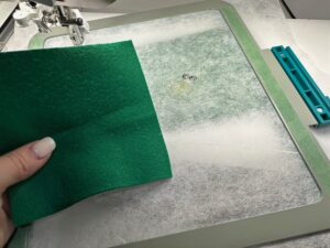 placing fabric on back of hoop