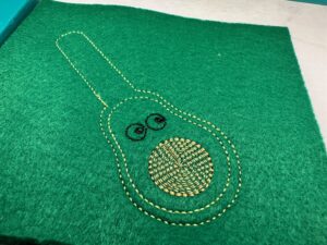 finished stitchout in the hoop for avocado guy key fob