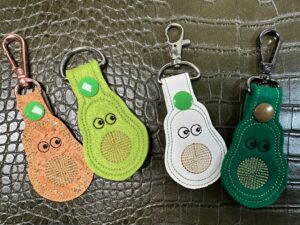 four finished key fobs on green background