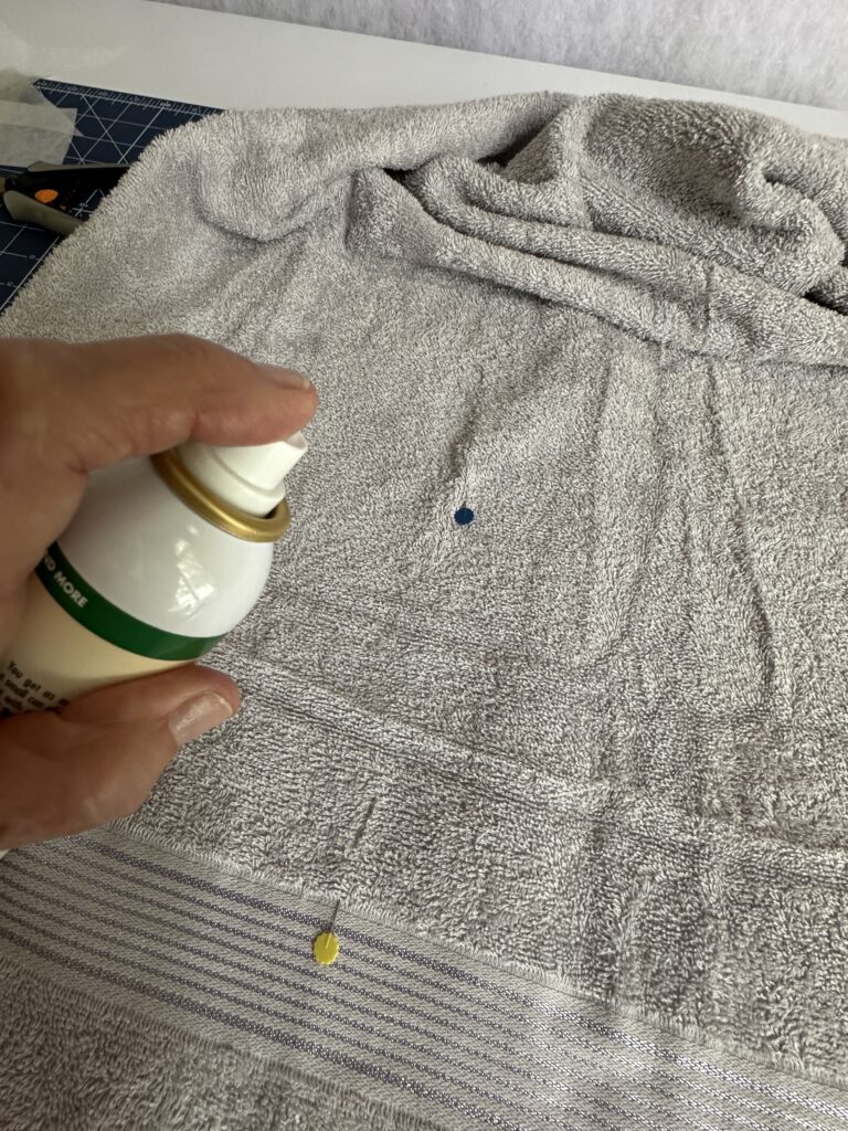 spraying KK2000 onto towel