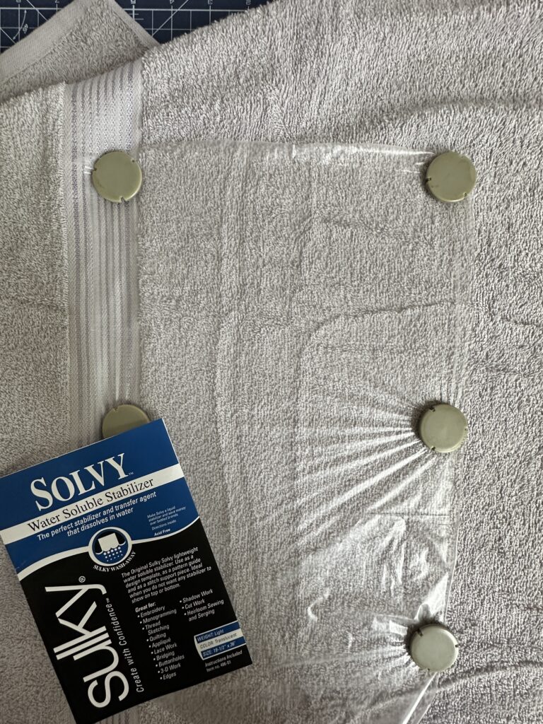 placing Sulky Solvy over towel on hoop