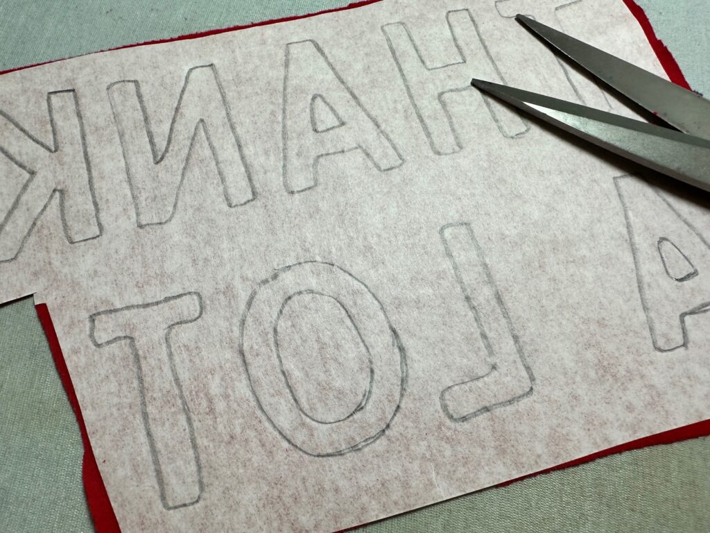 cutting out thanks a lot letters for applique