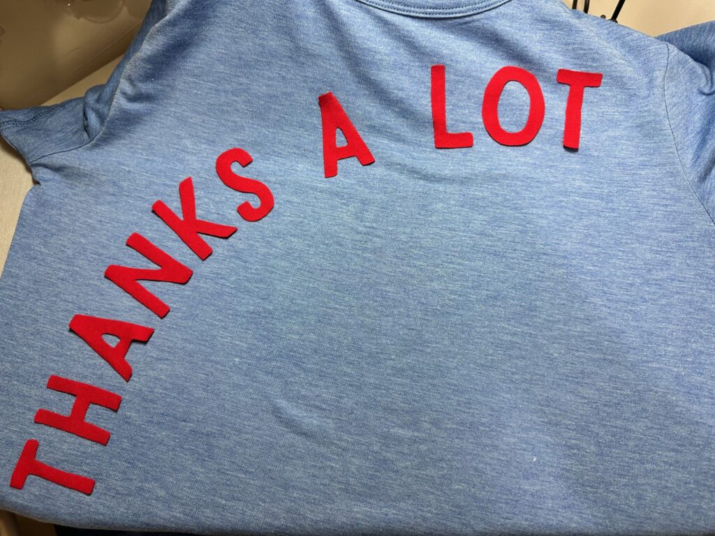 arrange thanks a lot lettering on t-shirt