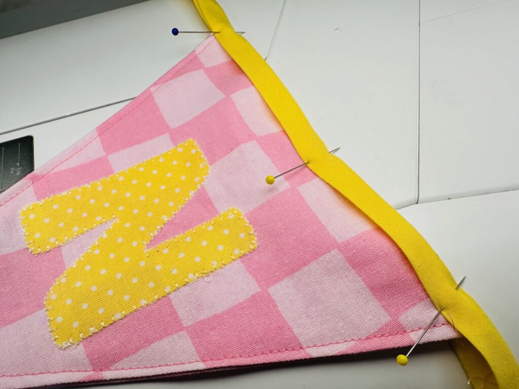 pin bias tape around each flag upper edge