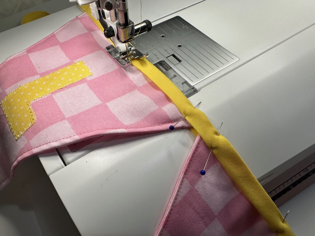 sewing along bias tape fold to secure flags