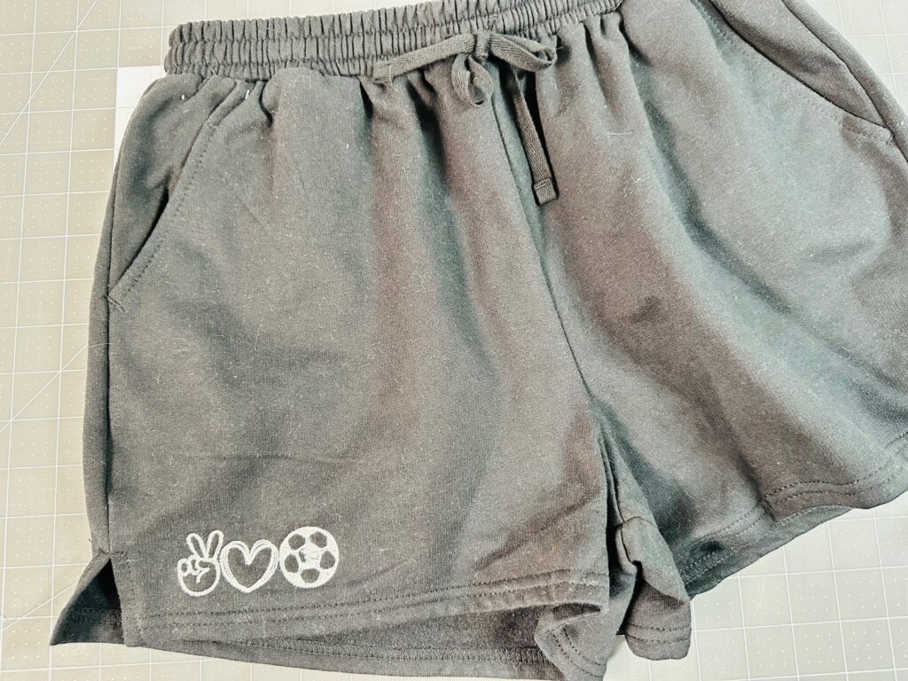 finished shorts with Peace Love Soccer machine embroidery design