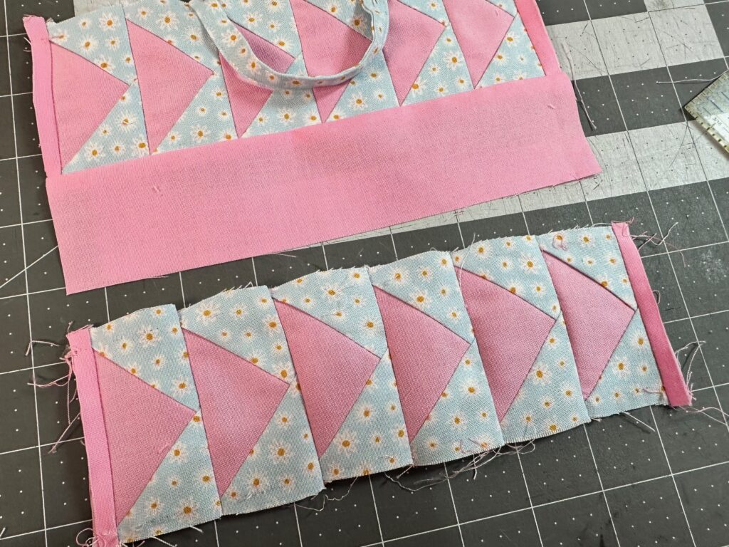 two flying geese panels stitched on table