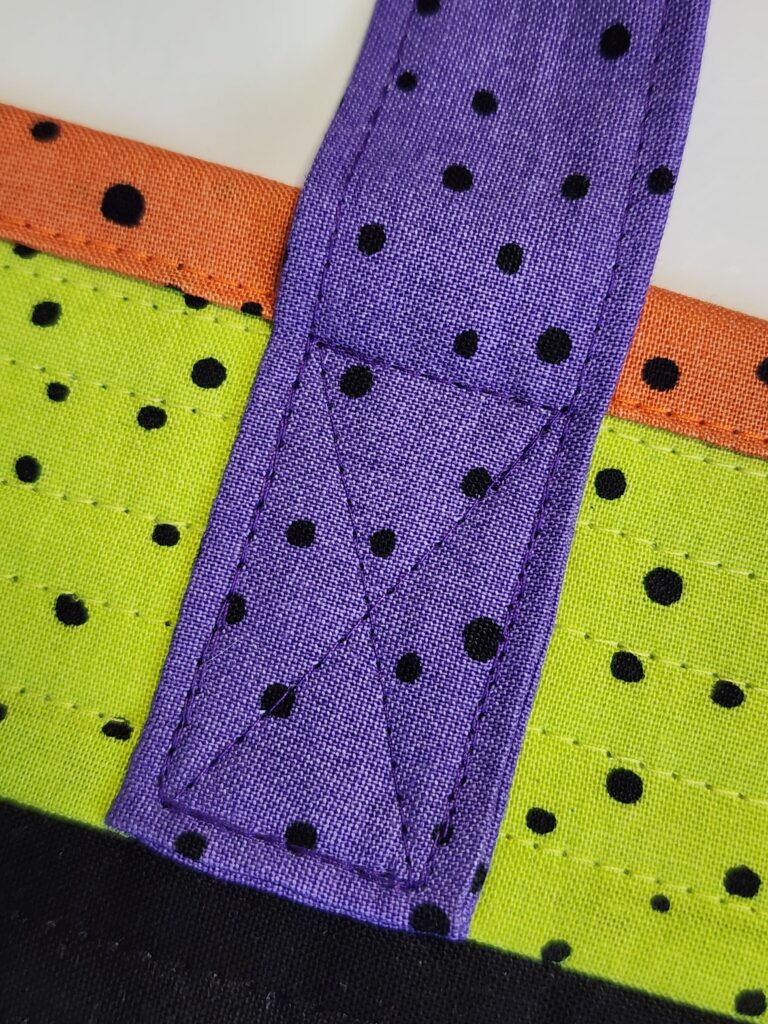 handle with X reinforcement stitching