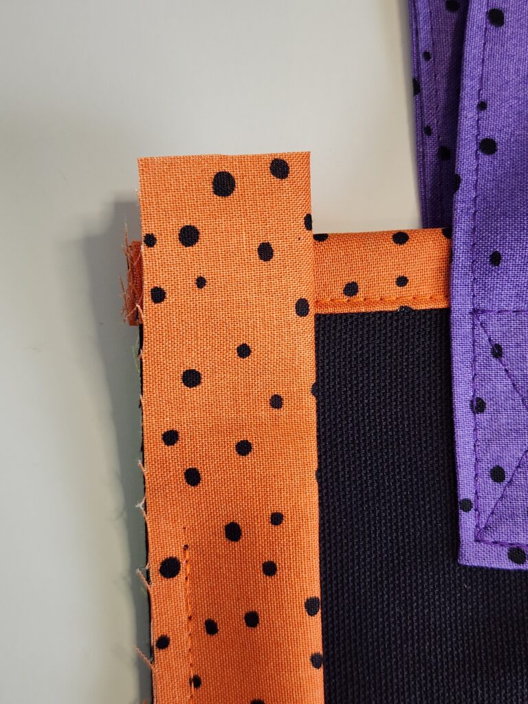 upper edge binding extending beyond edge