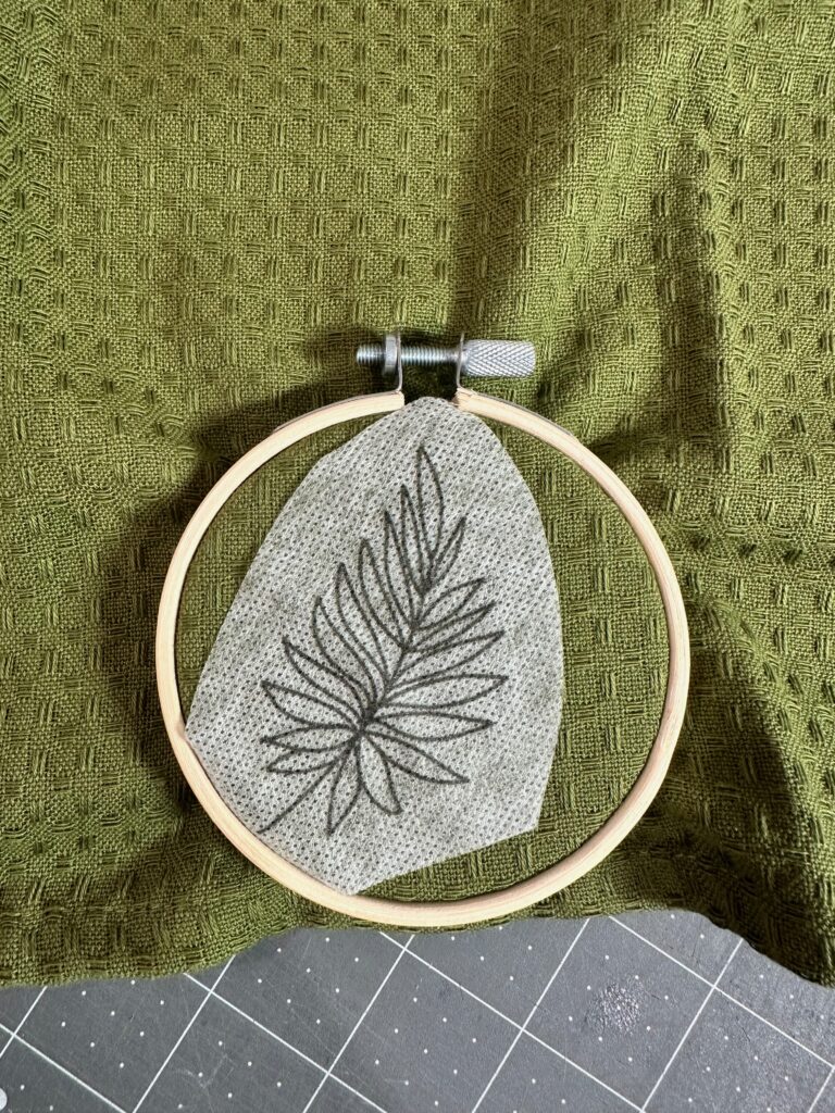 hooped towel with hand embroidery transfer sticker in center