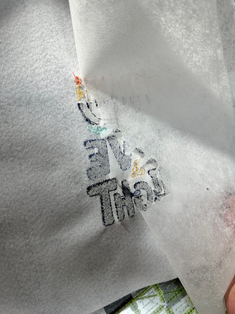 tearing away second layer of stabilizer for pillow