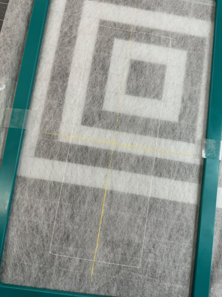 Smiling woman with short brown hair wearing a black top and pearl necklace.