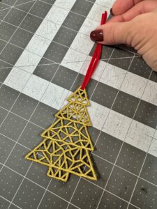 threading ribbon through freestanding lace for ornament