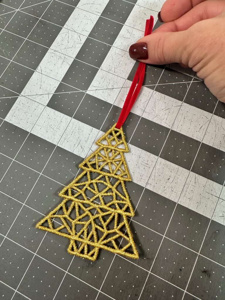 threading ribbon through freestanding lace for ornament