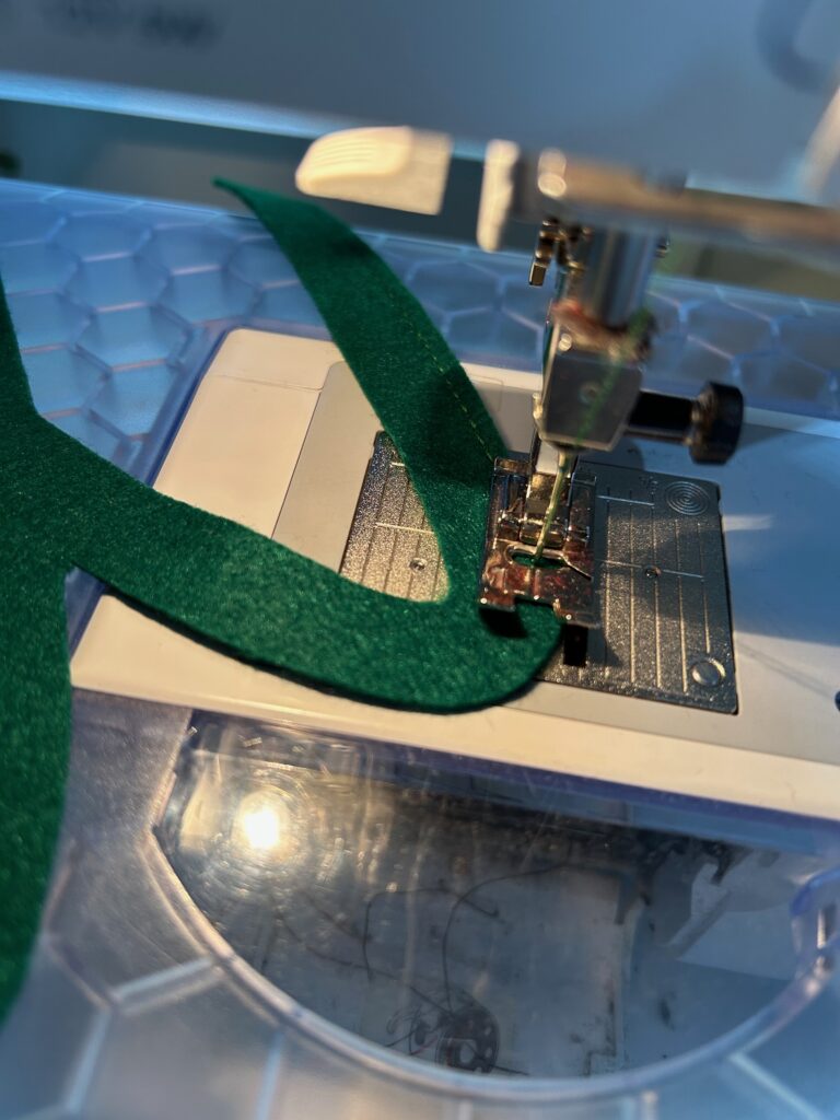 stitching Sant's suspenders