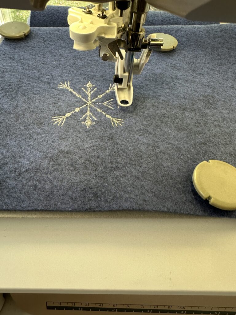 embroidering snowflake design with Sulky metallic thread