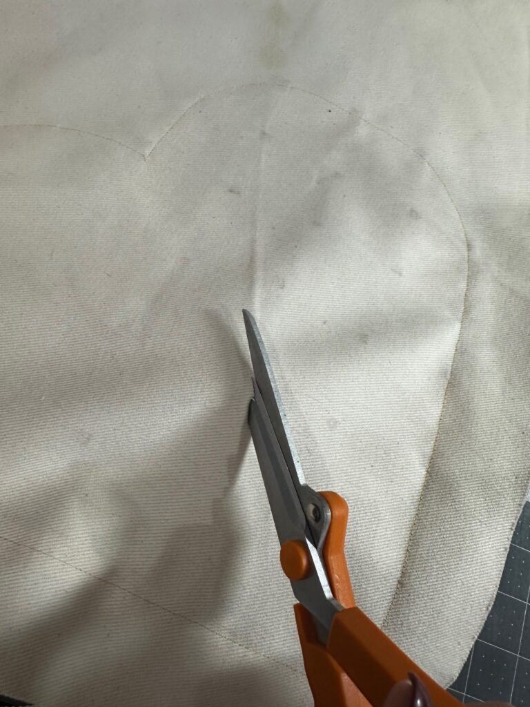 snipping into fabric to expose patchwork heart