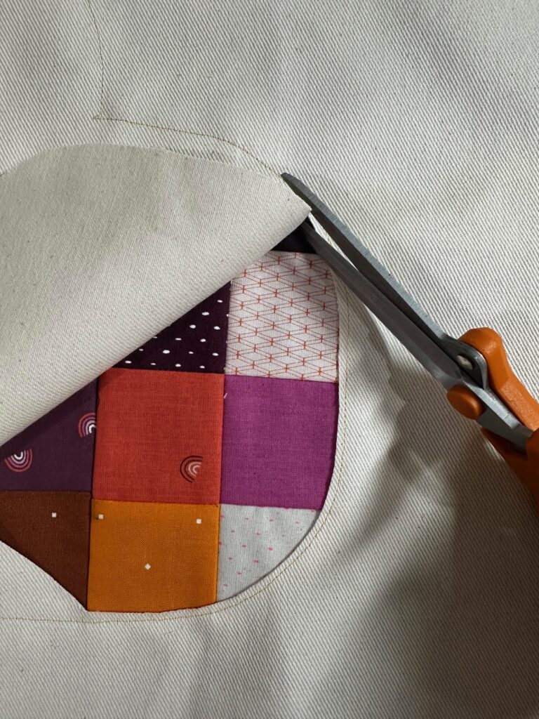 cutting away outer fabric for reverse appliqué